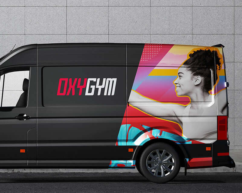 OXYGYM branded van design showcasing vibrant graphics and a fit model against a concrete background.