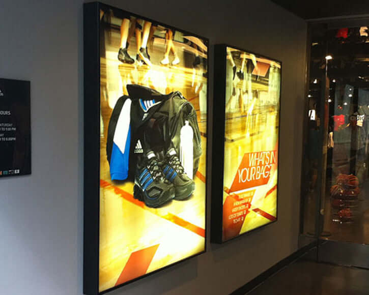 Metamark MD-BL2 Printable Backlit Polyester showcasing illuminated advertisements in a sports store.